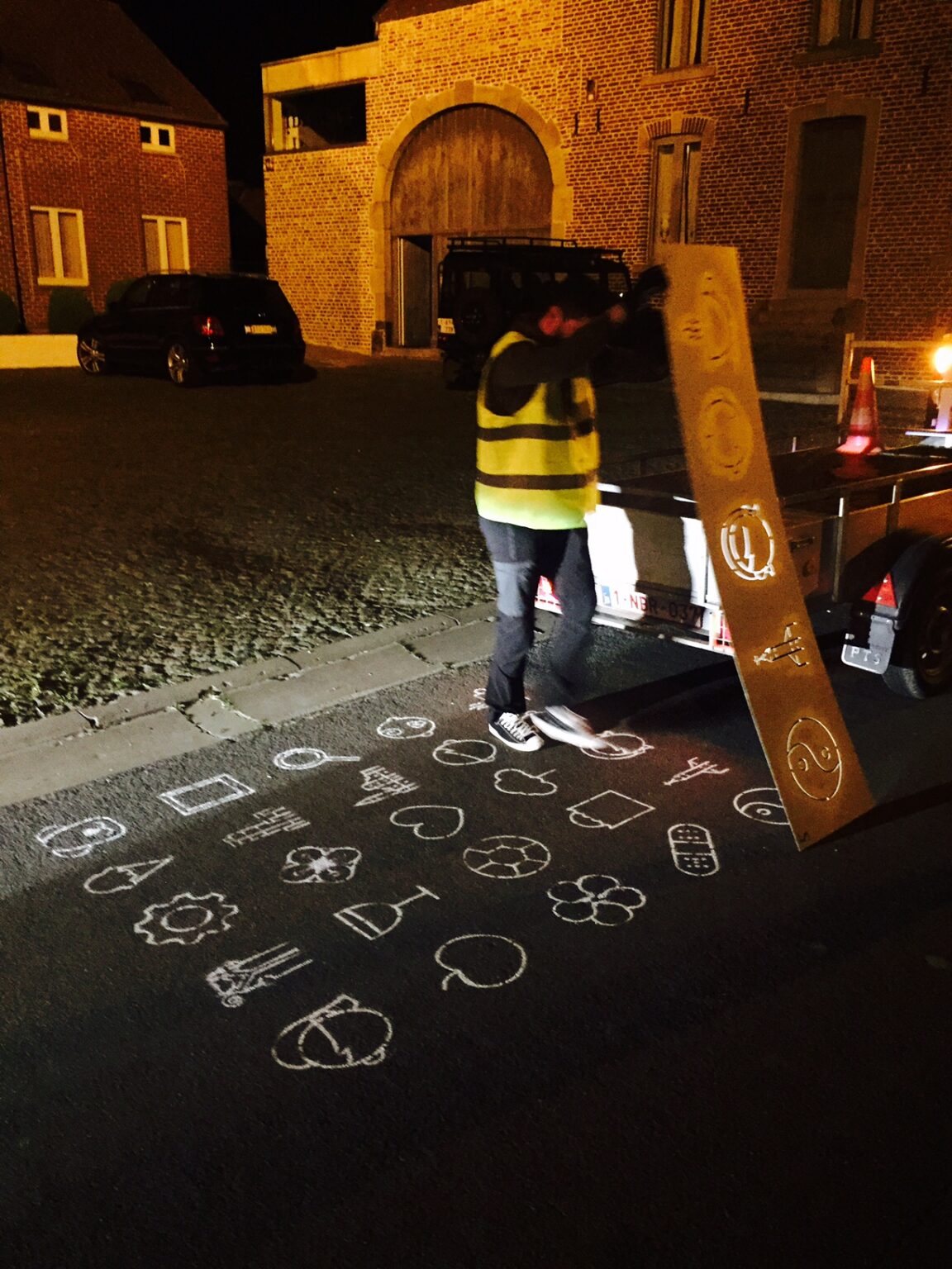 Man tekent sjabloon op straat 's nachts
